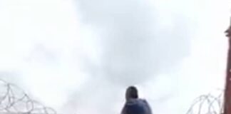 Naira scarcity: Bank officials caught on camera scaling fence to escape mob by customers.